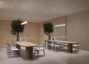 a dining room with tables and chairs and trees at PureJoy Hotel Langkawi in Kuah +38 photos