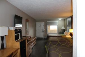 a hotel room with two beds and a television at Super 8 by Wyndham Fort Chiswell Wytheville Area in Max Meadows