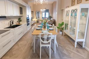 a kitchen with a table and chairs in it at Pawlina Boutique Residence in St. Paul's Bay