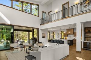 an open living room with a white couch and chairs at Onyx in Cle Elum