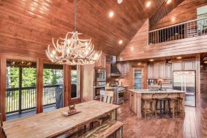a kitchen with a chandelier and a wooden ceiling at Crestview Lodge in Ronald