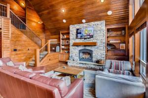 a living room with a couch and a stone fireplace at Crestview Lodge in Ronald