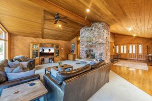 a living room with a couch and a stone fireplace at Lakeside in Ronald
