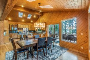 a kitchen and dining room with a table and chairs at Lakeside in Ronald