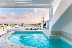 a swimming pool on the roof of a house at Casa Grande Santorini in Megalochori