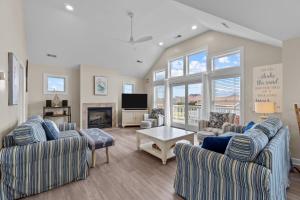 a living room with two couches and a fireplace at 7219 - C-Waves in Salvo
