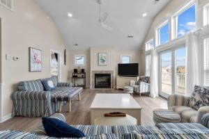 a living room with couches and a tv at 7219 - C-Waves in Salvo +38 photos