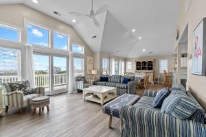 a large living room with couches and chairs and windows at 7219 - C-Waves in Salvo