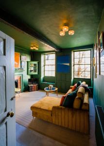 a person laying on a couch in a living room at The Old House Apartment in Shrewsbury