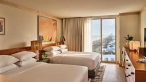 a hotel room with two beds and a window at Dune House Hotel & Spa in Atlantic Beach