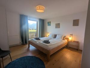 a bedroom with a large bed and a window at Apartment L i e b l i n g s o r t in Golling an der Salzach