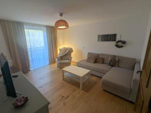 a living room with a couch and a table at Apartment L i e b l i n g s o r t in Golling an der Salzach