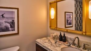 a bathroom with a sink and a mirror at Dune House Hotel & Spa in Atlantic Beach +29 photos
