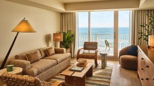 a living room with a couch and a table at Dune House Hotel & Spa in Atlantic Beach