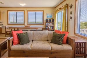 a living room with a couch with colorful pillows at 7504 - Sunrise-Sunset in Avon