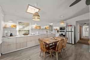a large kitchen with a wooden table and chairs at 7850 - Nepenthe in Frisco