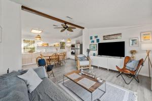a living room with a couch and a flat screen tv at 7850 - Nepenthe in Frisco