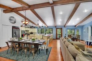 a kitchen and living room with a table and a couch at Driftwood in Ronald