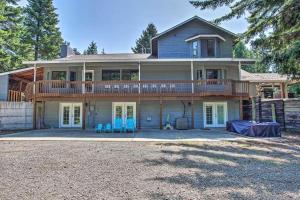 a large house with a deck and blue chairs at Driftwood in Ronald