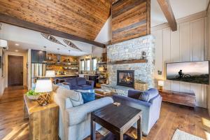 a living room with couches and a stone fireplace at Majestic Pines in Ronald
