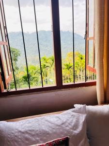 a bedroom with a window with a view of the mountains at Cinderella three arch view in Ella