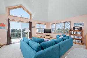a living room with a blue couch and a tv at 7838 - Wilder View in Frisco