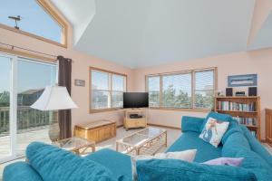 a living room with a blue couch and a tv at 7838 - Wilder View in Frisco