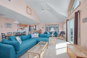 a living room with a blue couch and a table at 7838 - Wilder View in Frisco