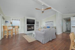a living room with a couch and a tv and a table at 7916 - Hatteras Vista in Hatteras