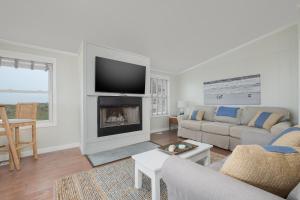 a living room with a couch and a fireplace at 7916 - Hatteras Vista in Hatteras