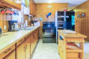 a kitchen with wooden cabinets and a black refrigerator at 7602 - Drydock in Avon