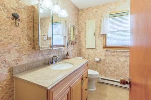 a bathroom with a sink and a toilet and a mirror at 7602 - Drydock in Avon +8 photos