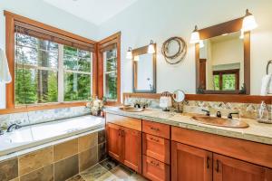 a bathroom with two sinks and a tub and a large window at Gathering Place in Cle Elum +54 photos