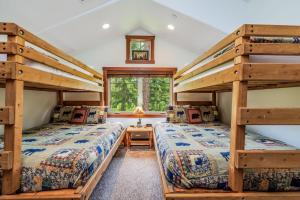 a bedroom with two bunk beds and a window at Gathering Place in Cle Elum