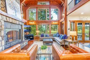 a living room with leather furniture and a stone fireplace at Wine Down in Cle Elum