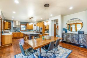 a kitchen and dining room with a wooden table and chairs at Wine Down in Cle Elum