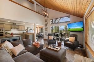 a living room with a couch and a tv at Coal Chute Lodge in Ronald