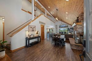 an open living room with a staircase and a dining room at Coal Chute Lodge in Ronald