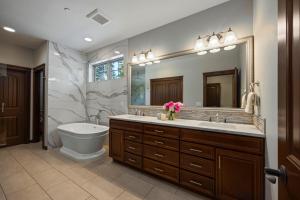 a bathroom with a sink and a toilet and a mirror at Basecamp at Suncadia in Cle Elum +43 photos