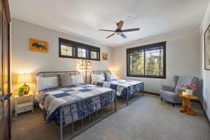 a bedroom with two beds and a ceiling fan at Basecamp at Suncadia in Cle Elum