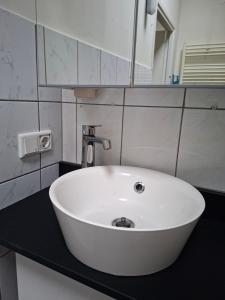 a white sink in a bathroom with a mirror at Zonneoord in Ede