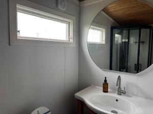 a bathroom with a sink and a mirror at Swedish Rustic Cabin perfect for bird watching in Emsworth