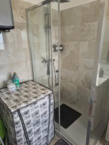 a shower stall with a glass door in a bathroom at My Sunset in Torvaianica +12 photos