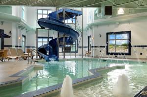 a pool with a water slide in a building at Canalta Wainwright in Wainwright