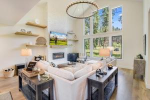 a living room with a large white couch and a fireplace at Suncadia Luxe in Cle Elum