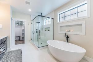 a white bathroom with a large tub and a glass shower at Suncadia Luxe in Cle Elum +47 photos