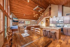 a kitchen with a wooden ceiling and a table and chairs at Huckleberry Hill in Ronald