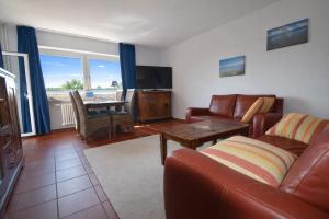 a living room with a couch and a table at fewo1846 - Ostseebad - Apartment mit 2 Schlafzimmern und Meerblick in Flensburg +12 photos