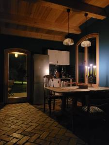 a dining room with a table and a kitchen at Alte Schmiede in Schwielochsee