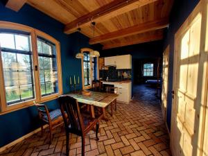 a kitchen with a table and chairs in a room at Alte Schmiede in Schwielochsee